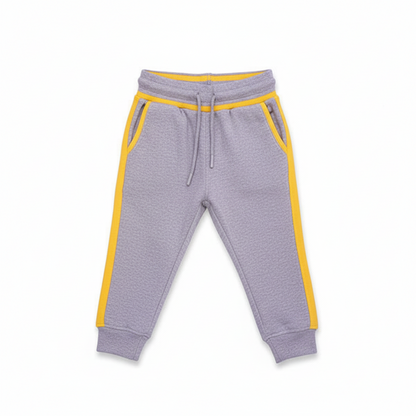 A pair of gray terry cloth trousers for children with yellow contrast accents on the pockets and waistband.