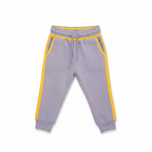 A pair of gray terry cloth trousers for children with yellow contrast accents on the pockets and waistband.