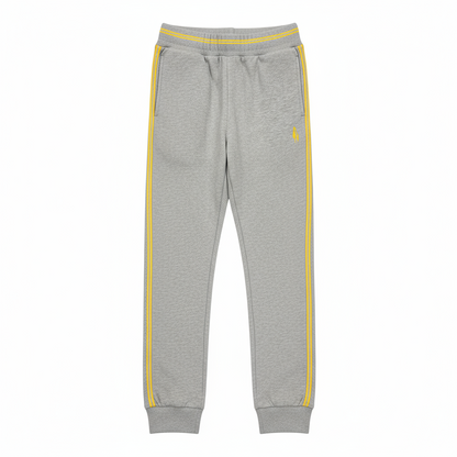 A pair of gray sports trousers with yellow stripes and a visible logo on the lower right side, designed for children.