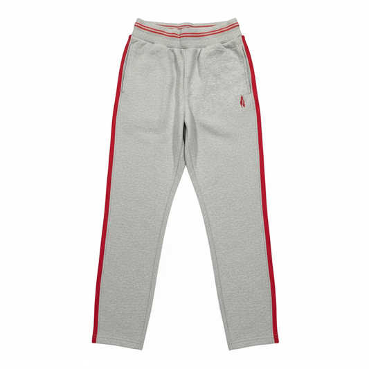A pair of gray sports trousers with red stripes on the side, displayed against a white background.