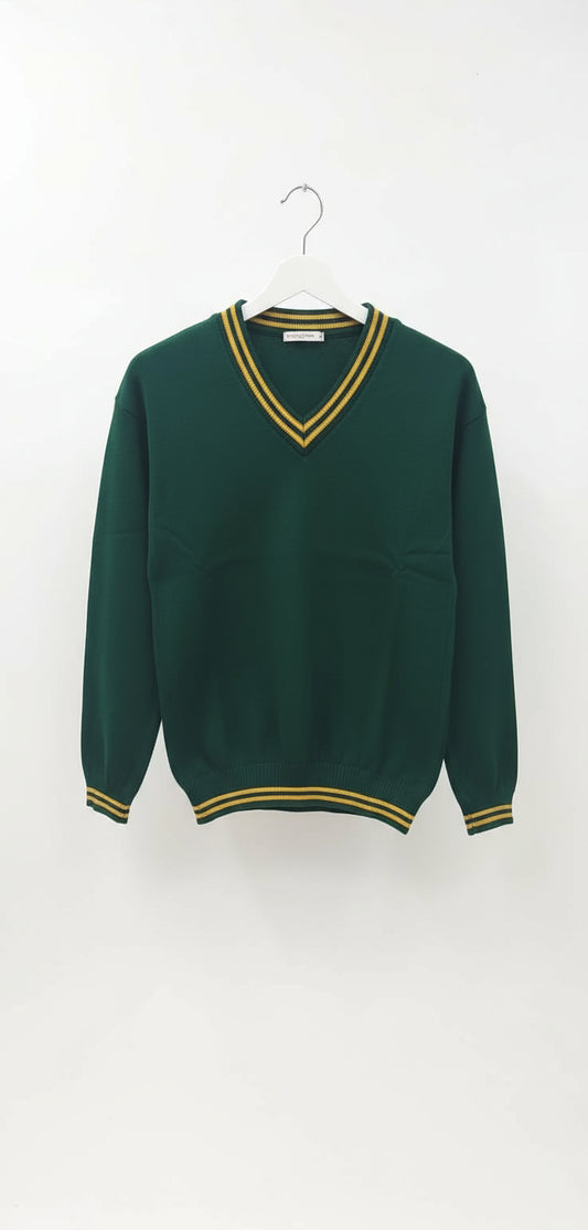 Green sweater with yellow trim on a hanger against a white wall.
