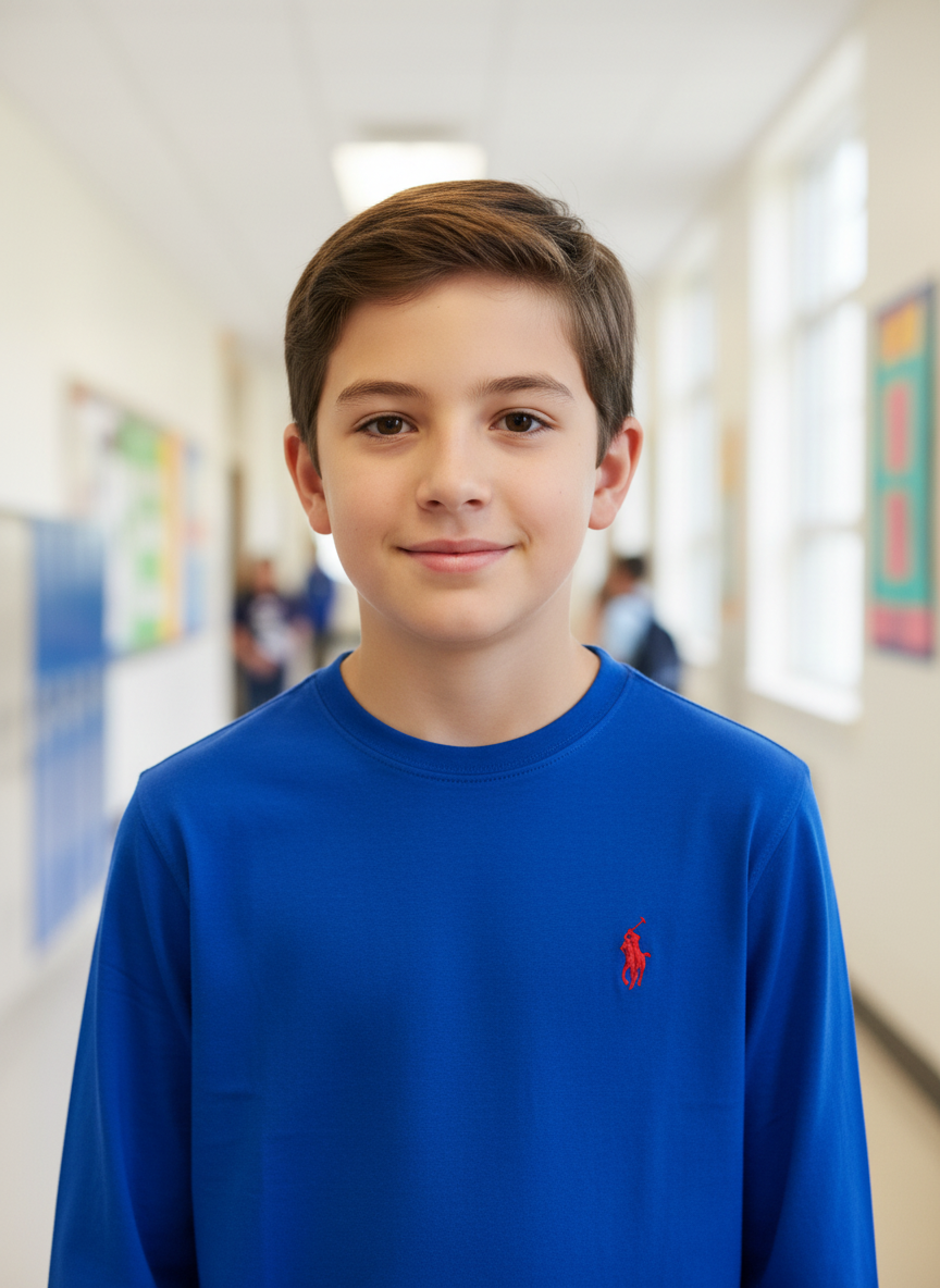 Blue long-sleeve shirt with a red logo on a hanger against a white wall.
