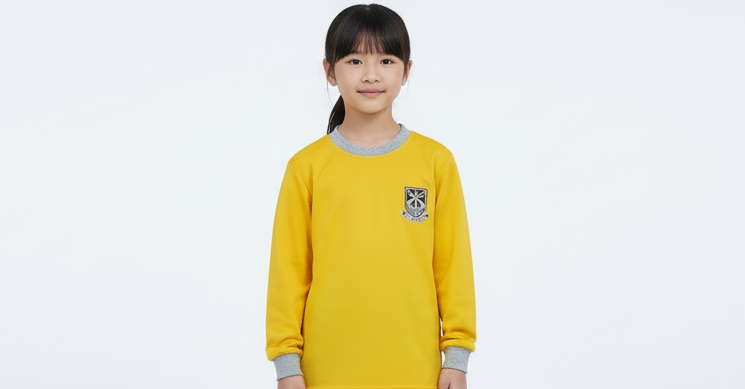 A yellow unisex long-sleeved sports shirt with a grey collar and a logo on the chest.